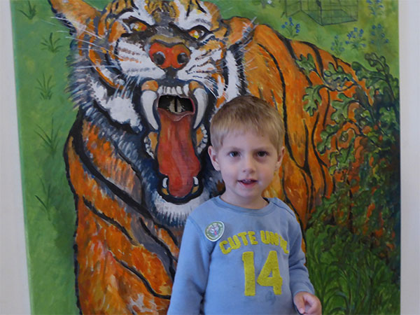 Young boy with donation tiger at museum